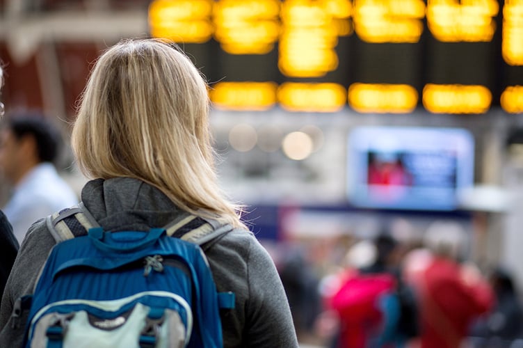 Pic of passenger looking at electronic train timetable