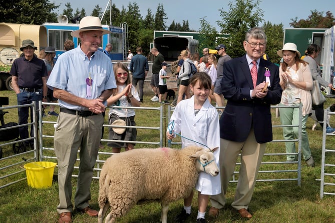 Young handler Eleanor Herbert with judge Lyndon Edwards and show committee member John Jenkins