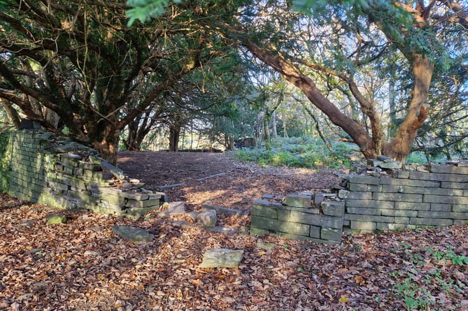 A damaged wall in a churchyard